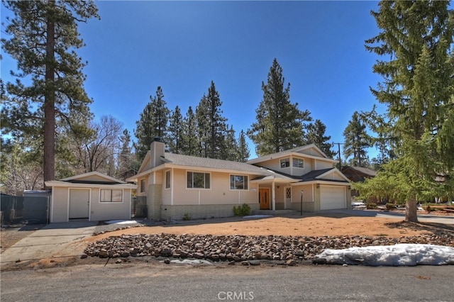 279 Bluebird Ct, Big Bear Lake, CA 92315 - view of front of property featuring an outbuilding, fence, driveway, a garage, and a chimney