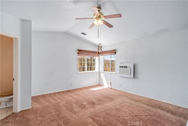 14935 Elizabeth Lake Rd, Lake Elizabeth, CA 93532 - carpeted empty room with a wall mounted air conditioner, a textured ceiling, visible vents, a ceiling fan, and vaulted ceiling