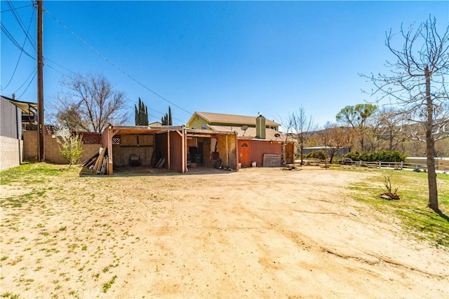 14935 Elizabeth Lake Rd, Lake Elizabeth, CA 93532 - rear view of house with an outdoor structure and fence