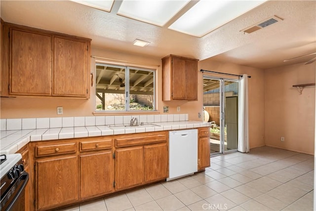 14935 Elizabeth Lake Rd, Lake Elizabeth, CA 93532 - kitchen featuring gas stove, a sink, visible vents, dishwasher, and brown cabinets