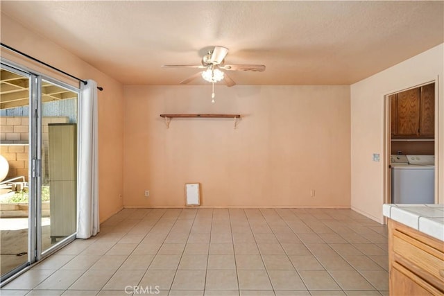 14935 Elizabeth Lake Rd, Lake Elizabeth, CA 93532 - unfurnished room with washer and clothes dryer, a textured ceiling, light tile patterned floors, and a ceiling fan
