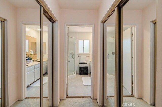 hall with light carpet and baseboards