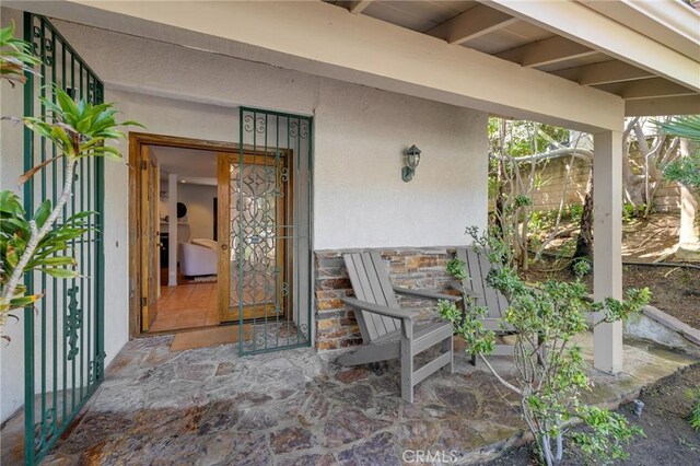 property entrance with stucco siding