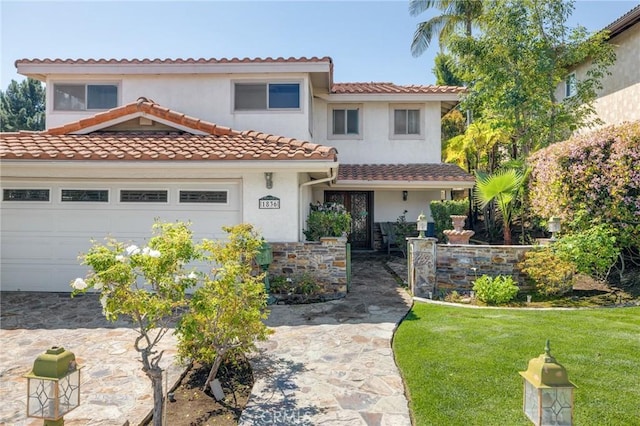 mediterranean / spanish-style house featuring a tiled roof, a front yard, an attached garage, and stucco siding