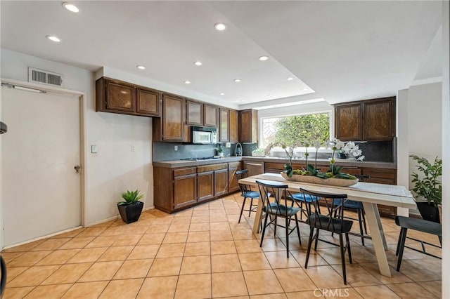 kitchen featuring recessed lighting, tasteful backsplash, visible vents, and light tile patterned flooring