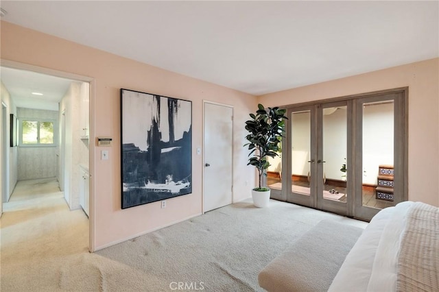 living area featuring french doors and carpet floors