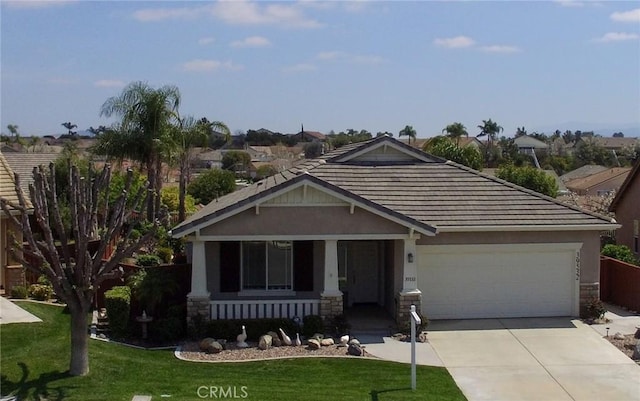 39532 Corbett Canyon Cir, Murrieta, CA 92563 - craftsman-style home with concrete driveway, stone siding, a tiled roof, a front lawn, and a garage