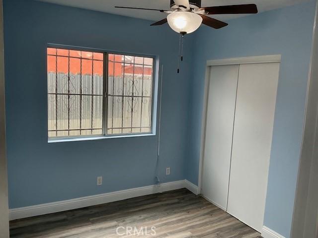 4522 W 156th St, Lawndale, CA 90260 - unfurnished bedroom featuring wood finished floors, a closet, baseboards, and a ceiling fan