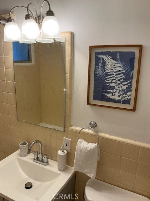 4522 W 156th St, Lawndale, CA 90260 - bathroom with tile walls, decorative backsplash, toilet, and vanity