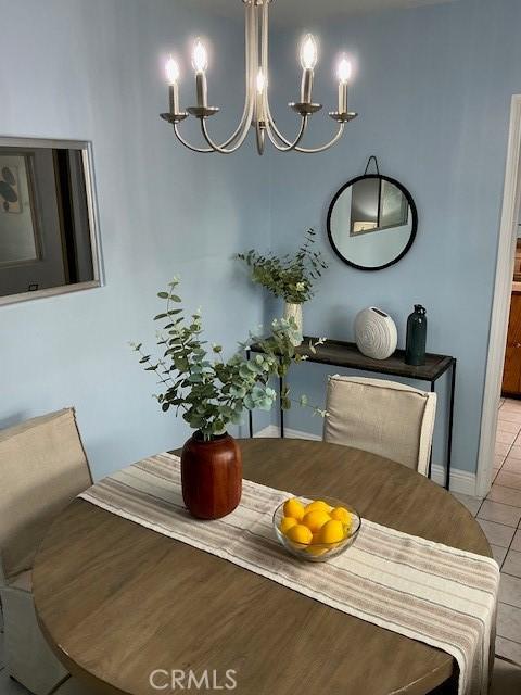 4522 W 156th St, Lawndale, CA 90260 - dining area with a chandelier, light tile patterned flooring, and baseboards