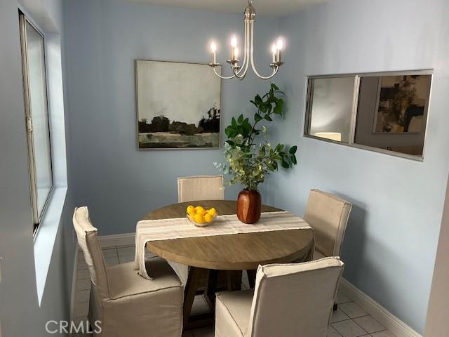4522 W 156th St, Lawndale, CA 90260 - dining space with a chandelier and tile patterned floors