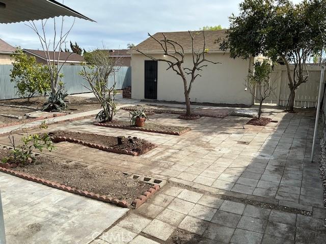 exterior space with a patio area and a fenced backyard