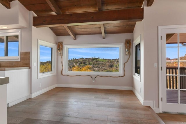 interior space with wood ceiling, plenty of natural light, and light wood-style floors