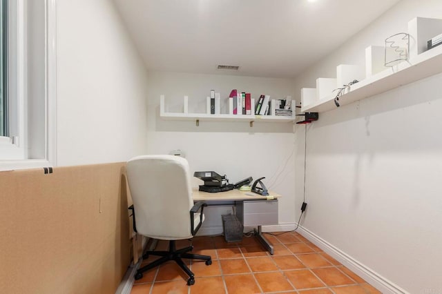 office area with baseboards, visible vents, and light tile patterned floors