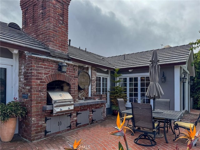 view of patio / terrace with a grill, an outdoor kitchen, and outdoor dining area