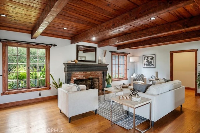 living room with beam ceiling, wooden ceiling, and wood finished floors