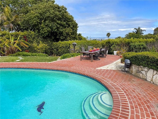 pool featuring a patio and outdoor dining area