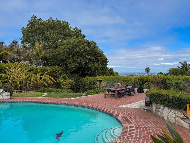 pool featuring outdoor dining area and a patio area