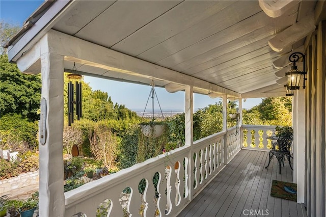 wooden terrace featuring covered porch