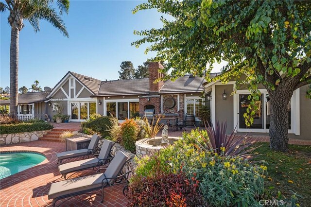 2501 Novato Pl, Palos Verdes Estates, CA 90274 - rear view of property featuring a chimney, a patio area, a tiled roof, and stucco siding