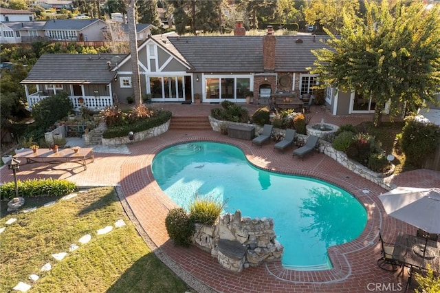 outdoor pool featuring a deck and a patio area