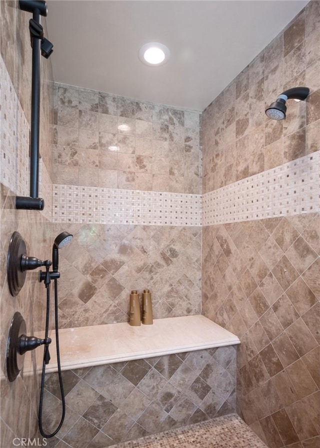 full bath featuring tiled shower