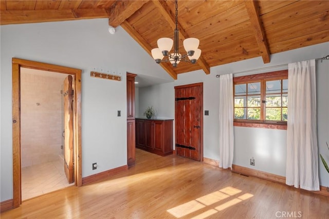 unfurnished dining area featuring wooden ceiling, vaulted ceiling with beams, light wood finished floors, baseboards, and a notable chandelier