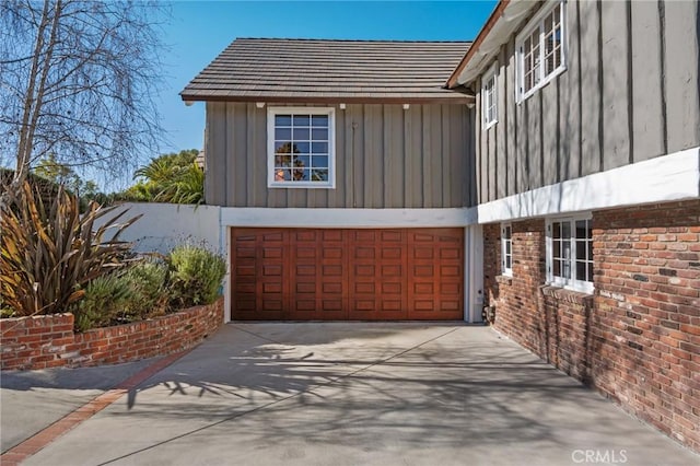 2501 Novato Pl, Palos Verdes Estates, CA 90274 - view of side of home featuring board and batten siding, an attached garage, driveway, and brick siding
