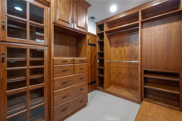 walk in closet featuring visible vents and carpet floors