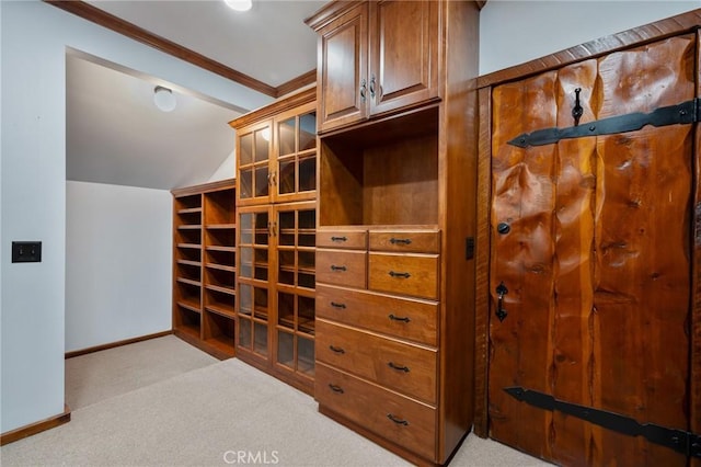 walk in closet with lofted ceiling and light carpet