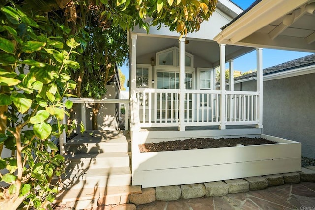 entrance to property featuring stucco siding and covered porch
