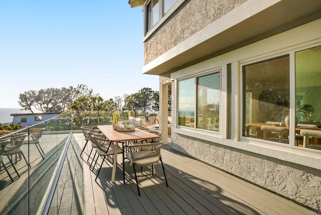wooden deck featuring outdoor dining area