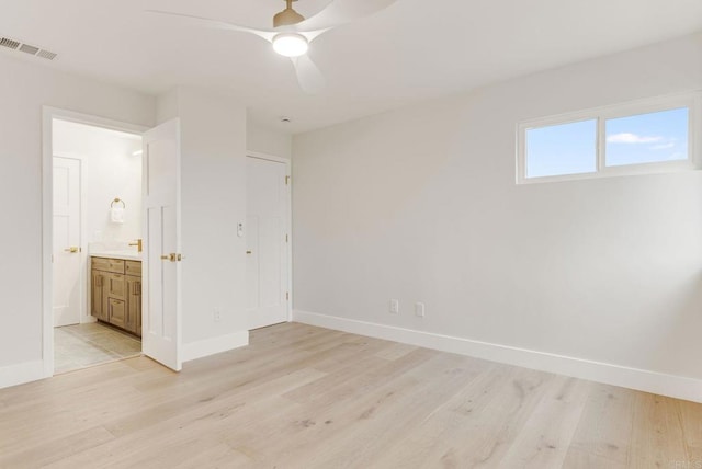 unfurnished bedroom with visible vents, light wood-type flooring, and baseboards