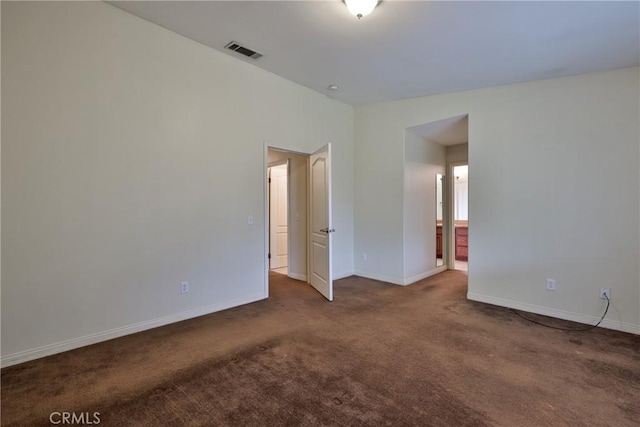 unfurnished room with visible vents, baseboards, and carpet floors