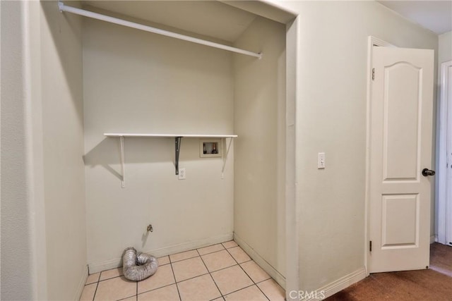 laundry area featuring light tile patterned floors, laundry area, baseboards, and hookup for a washing machine