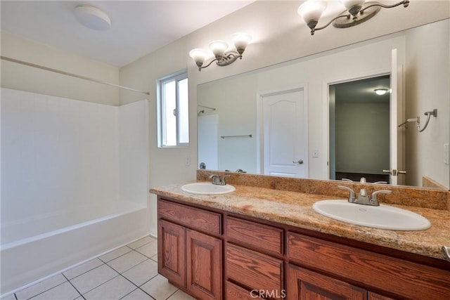 full bathroom with tile patterned floors, double vanity,  shower combination, and a sink
