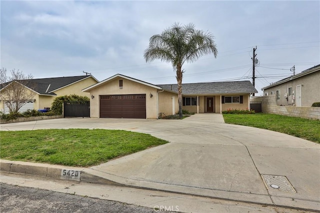 single story home featuring stucco siding, driveway, an attached garage, a front yard, and fence