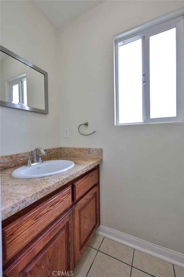 bathroom featuring tile patterned floors, vanity, and baseboards