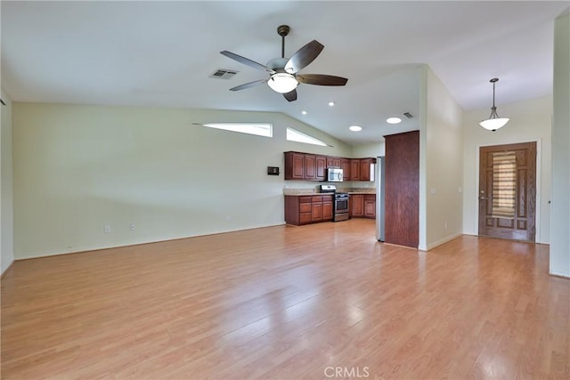 unfurnished living room featuring visible vents, a ceiling fan, light wood-style floors, and lofted ceiling