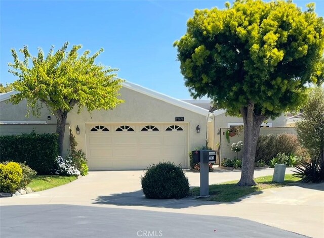 22876 Montalvo Rd, Laguna Niguel, CA 92677 - obstructed view of property with a garage, stucco siding, and driveway