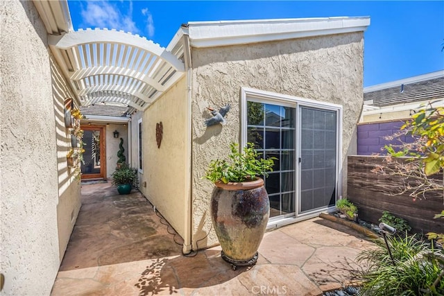 22876 Montalvo Rd, Laguna Niguel, CA 92677 - view of exterior entry with stucco siding and a patio area