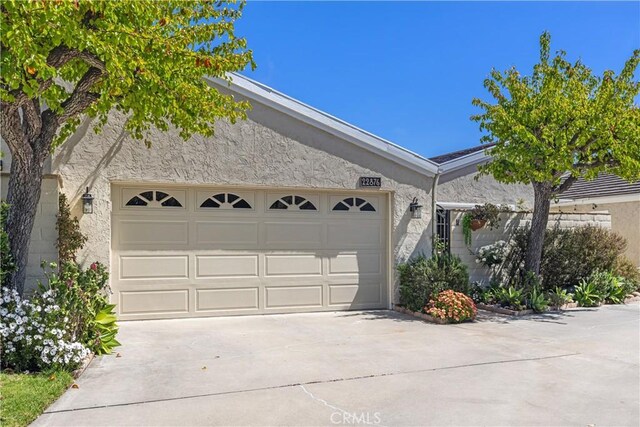 22876 Montalvo Rd, Laguna Niguel, CA 92677 - view of front facade featuring stucco siding, driveway, and a garage