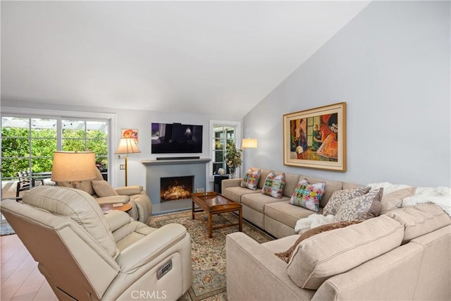 22876 Montalvo Rd, Laguna Niguel, CA 92677 - living room with lofted ceiling, healthy amount of natural light, and a lit fireplace
