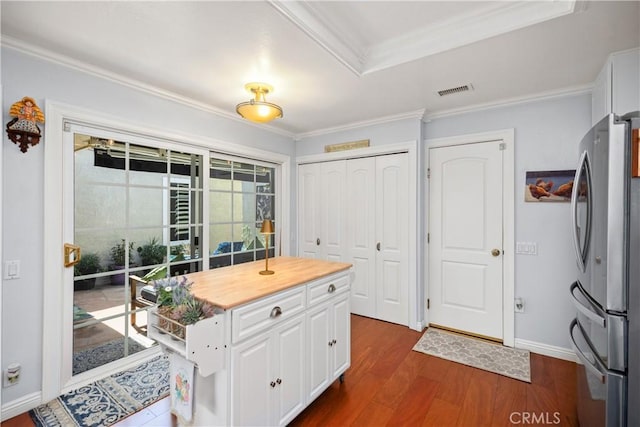 22876 Montalvo Rd, Laguna Niguel, CA 92677 - kitchen featuring freestanding refrigerator, crown molding, white cabinets, dark wood finished floors, and baseboards