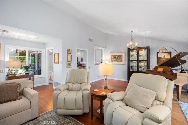 22876 Montalvo Rd, Laguna Niguel, CA 92677 - living area featuring a chandelier, lofted ceiling, wood finished floors, and baseboards
