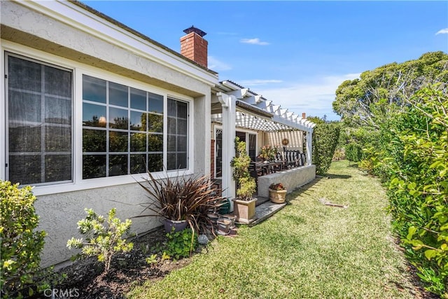 22876 Montalvo Rd, Laguna Niguel, CA 92677 - view of side of property with a pergola, a chimney, a yard, and stucco siding