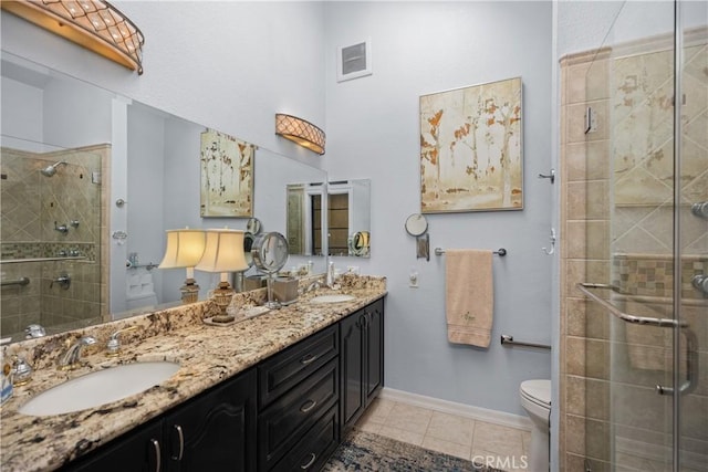 22876 Montalvo Rd, Laguna Niguel, CA 92677 - full bath with toilet, double vanity, a stall shower, tile patterned floors, and baseboards