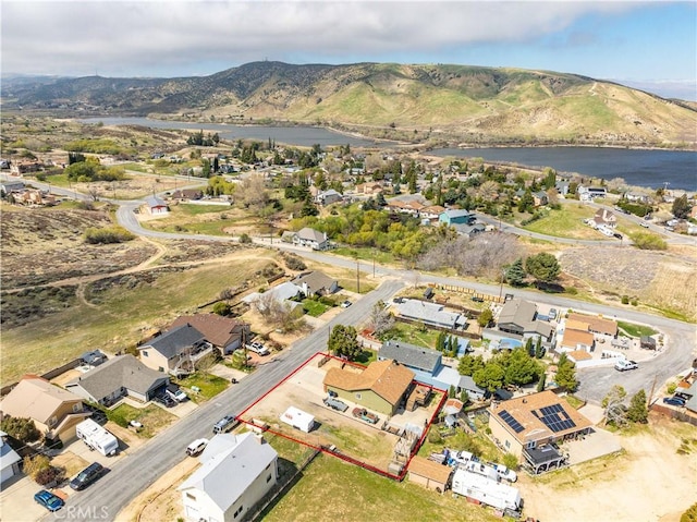 drone / aerial view with a residential view and a water and mountain view
