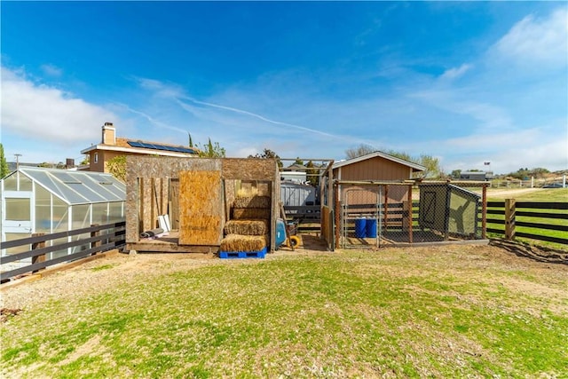 view of yard with exterior structure, an outbuilding, and fence