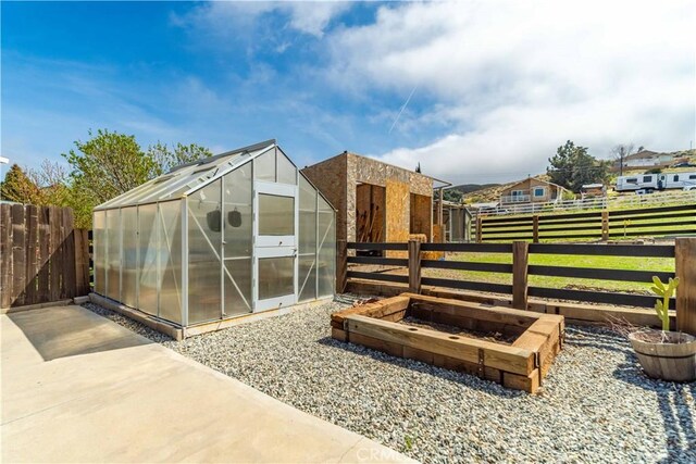 view of greenhouse with fence